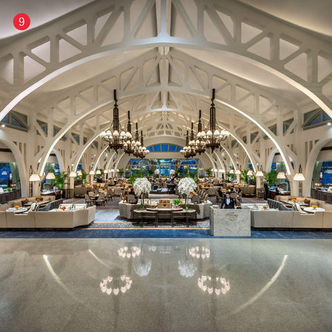 Interior of Clifford Pier, an open indoor space with high-arched ceilings, chandeliers, polished floors, showcasing heritage architecture and elegant furnishings