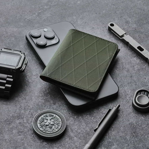 Ark Bifold Wallet X-PAC VX21: Dark Green sits sleek among EDC gear—phone, watch, tools—showcasing rugged style, compact form, and everyday versatility