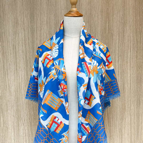 Mannequin wearing a blue Bras Basah and Bugis scarf with colorful geometric pattern