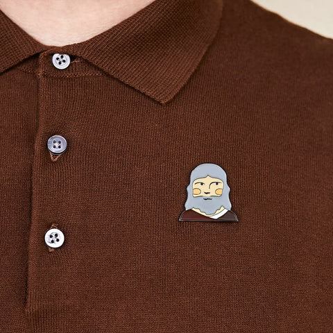 A model proudly wears a enamel pin from Chatty Feet featuring Leonardo