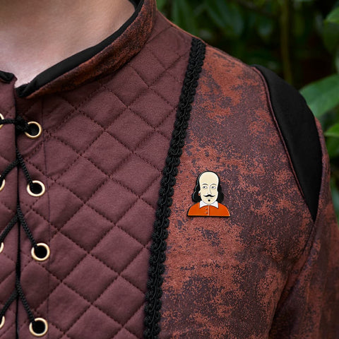A model adding a touch of literature flair with the Chatty Feet William enamel pin