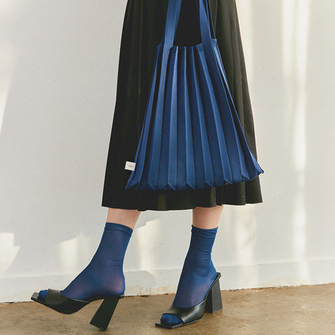 Pleatsmama Shoulder Bag Solid in navy, s—styled on model for a chic, fluid look that moves beautifully with every step