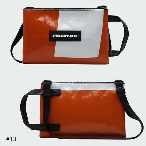 Front and back views of FREITAG F272 EDDIE crossbody bag, orange and white with black handle and strap.