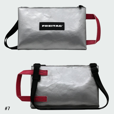 Front and back views of FREITAG F272 EDDIE crossbody bag, silver with pink handle and black strap.
