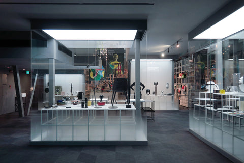 Award-winning products displayed behind glass panels, showcasing the interior of a museum exhibit
