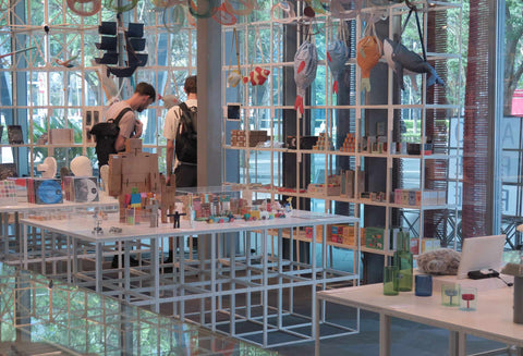 Design museum shop set up with white grids and colourful design gifts and unique products on display