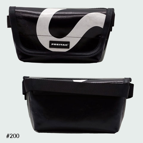 FREITAG F40 Jamie hip bag in black with bold white swirl graphic, upcycled truck tarp belt bag, front and back views.