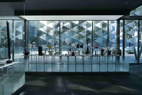 Red Dot Award Product design exhibition on display inside a glass panel with Marina bay as background