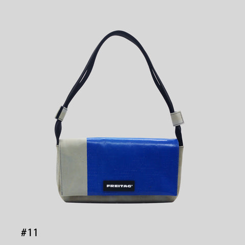 Front view of FREITAG F171 LAURA shoulder bag, grey and blue with black strap.