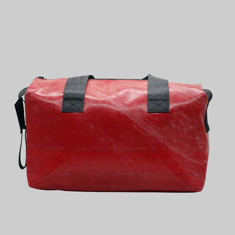 Back view of FREITAG F45 LOIS sports bag with black handles, plain red.
