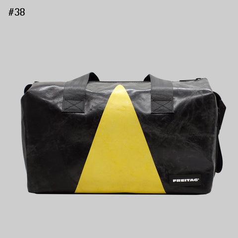 Front view of FREITAG F45 LOIS sports bag with black handles, black and yellow.
