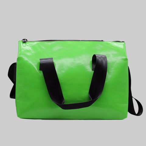 A FREITAG F45 LOIS Sports Bag back view image with a bold, high-saturation neon green body paired with deep black straps and trim, creating a sharp, high-contrast and eye-catching look