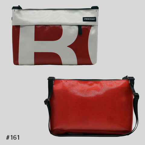 FREITAG F553 LOU shoulder bag in red and white with bold graphic print, upcycled truck tarp crossbody, front and back views.