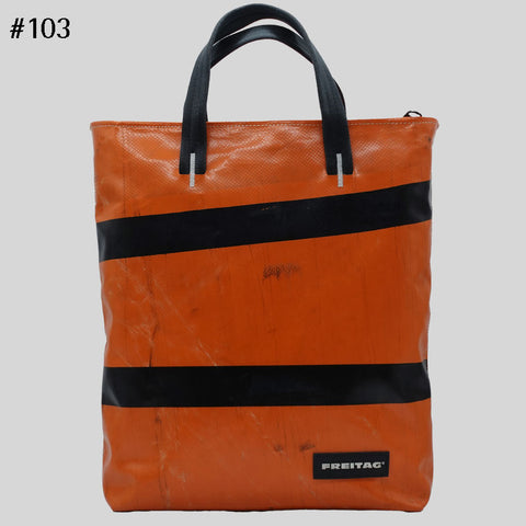 Front view of orange FREITAG F202 LELAND tote bag with black handles, two black stripes.