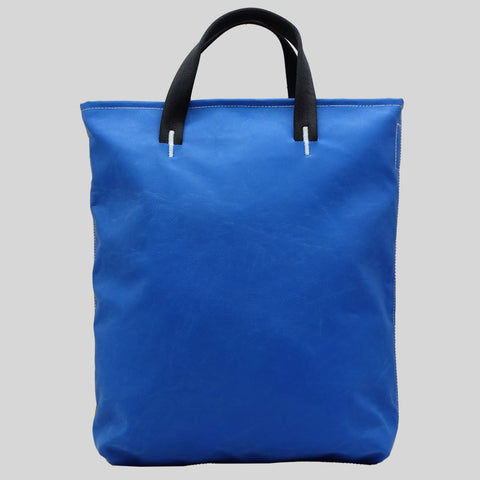 Back view of FREITAG F202 LELAND tote bag with black handles, plain blue.