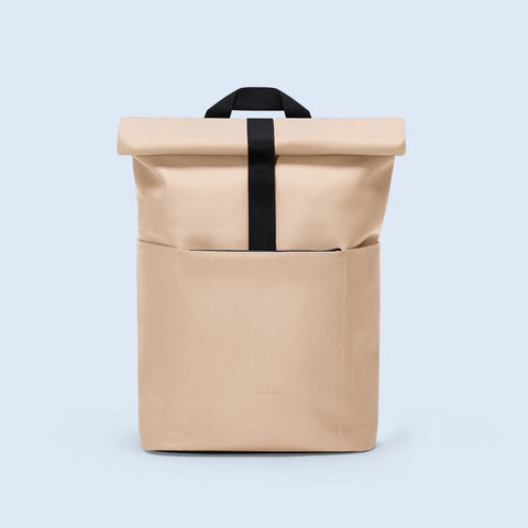 Ucon Acrobatics Hajo Mini Backpack Lotus Series with light almond colour with a roll up top and black strap made from polyurethane and polyester material