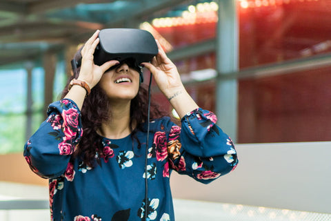 Visitor wearing a VR headset with a blurred red mesh background