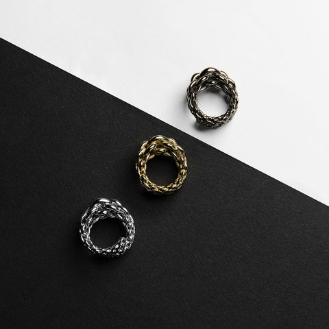 Three Magna rings in gold, silver and copper which embodies the oversized forms and concept of chains into a sculptural and distinctive jewel