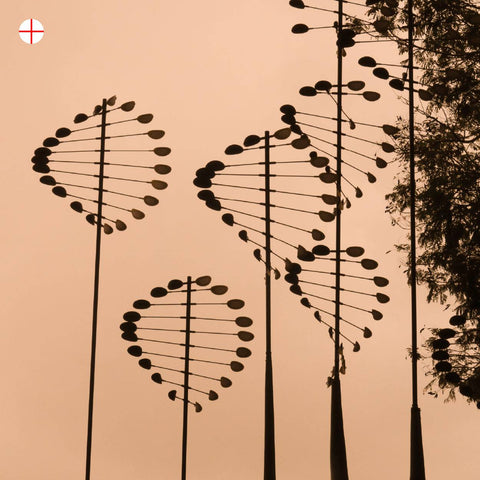 Decorative metal sculptures resembling DNA helixes at Marina bay against an evening sky background