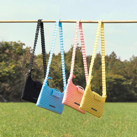 A outdoor shoot of Pleatsmama New Melody Bag M in all the 4 different vibrant and adorable colours