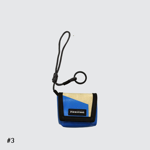 Front view of FREITAG F213 Mini Messenger key holder in blue and offwhite with nylon cord.
