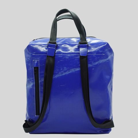 Back view of FREITAG F201 PETE backpack in blue with black handles, scratched surface and a zip pocket.