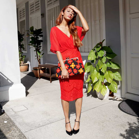 Model holds the Cocoonese Clasp Sling Bag-White Rain Lily (Black) as a clutch—effortless style with a modern, trendy edgy vibe