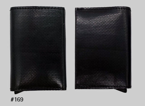 Front and back views of black FREITAG F705 SECRID Slimwallet RFID wallet with black stitching and a metal card slider at the base.
