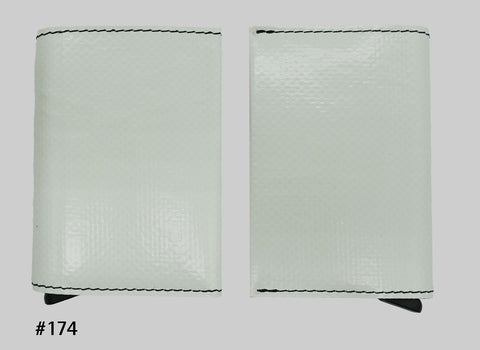 Front and back views of white FREITAG F705 SECRID Slimwallet RFID wallet with black stitching and a metal card slider at the base