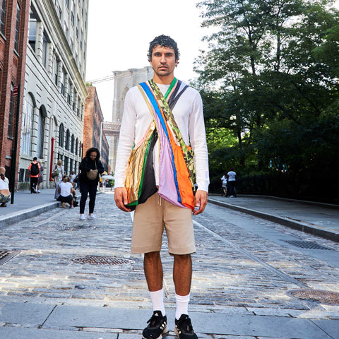 Model carrying multiple colours of Tetra tote bag as crossbody bags