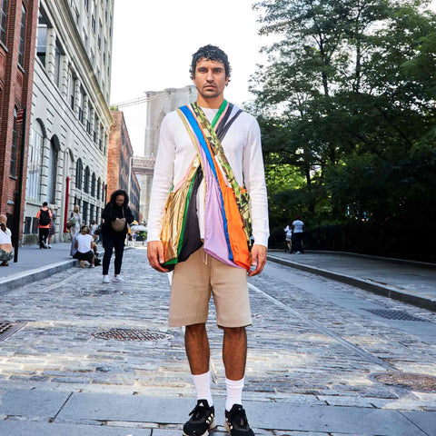 Model carrying multiple colours of Tetra tote bag as crossbody bags