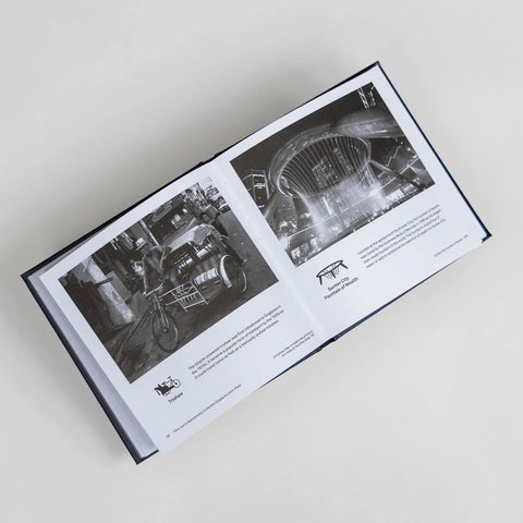 Open book showing black and white photographs on a light gray background