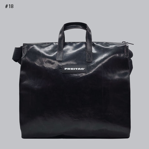 Front view of FREITAG F275 TILDA tote bag, all black with black handles and shoulder strap