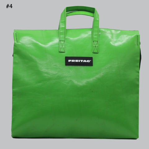 FREITAG F275 TILDA frontal view in a vibrant, bright green—almost neon—with a glossy, reflective finish