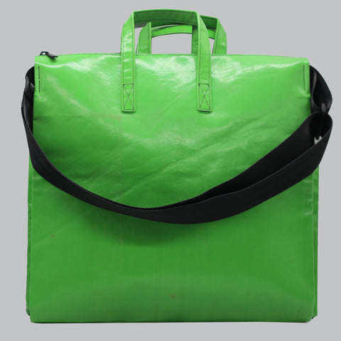 FREITAG F275 TILDA back view with shoulder strap shown and in bright green—almost neon—with a glossy, reflective finish