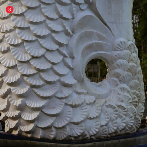 Close-up view of the Merlion’s fin-textured white stone sculpture along Marina Bay