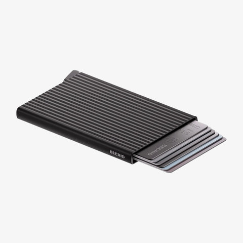 SECRID Cardprotector Fluted-Black shown with cards partially ejected, highlighting its slim, grooved design and easy-access mechanism
