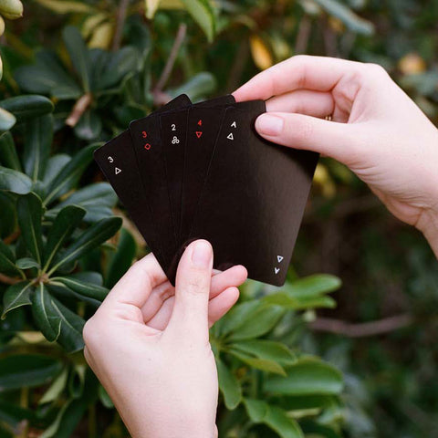 Areaware Minim Cards in hand —sleek black design, making every game feel stylish