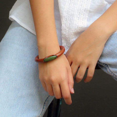A model showcasing the brown olive ivory bracelet which gives its simplicity design and colour to suit all colours