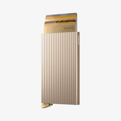 SECRID Cardprotector Fluted-Cashmere with cards partially fanned out, showcasing its grooved finish, slim build, and quick-access mechanism