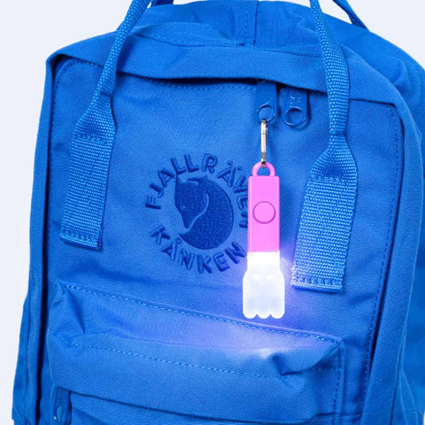 Lightstick Kids Ghost Pink: cute glowing clip on a backpack zipper—bright, fun & secure for safe, stylish visibility on every adventure
