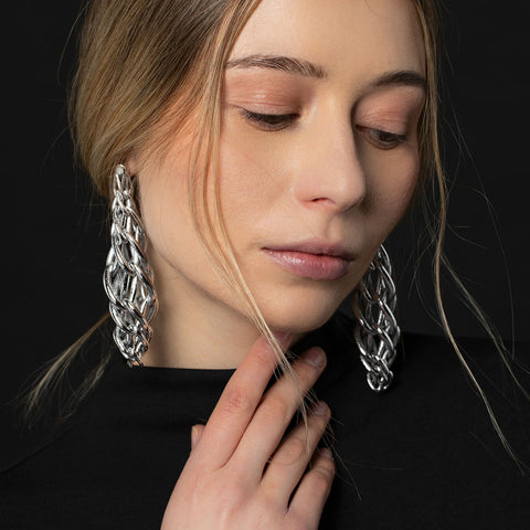 Model wearing Silver Mason 203 Endos earring design by Travis Fitch which inspired by inner structures and skeletal architectures
