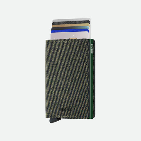 A compact Secrid wallet in Twist Green, a textured woven fabric exterior and a sleek green aluminum core, with cards fanned for quick access