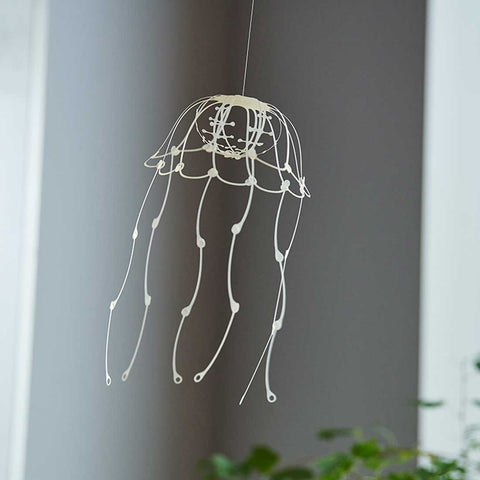 Finished piece of YURAYURA Wind Jelly Fish Hanging, shown at a slanted angle, by Fukunaga Print Co., Ltd