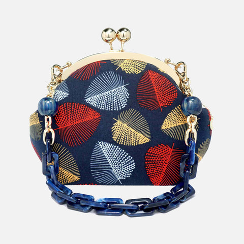 Cocoonese Arcylic Chain Handle Clasp Sling Bag-Fall (Red Black) with bold leaf patterns, gold clasp, and chunky blue chain for a chic statement look