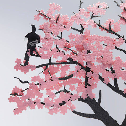 A close up view on the paper craft architectural model pink cherry blossom tree with ninja in silhouette at a 1/100 scale
