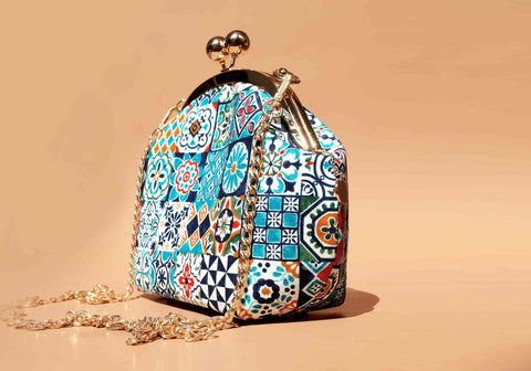 Cocoonese Arcylic Chain Handle Clasp Sling Bag-Peranakan Tiles at an angled side view, showcasing geometric tile patterns and glossy chain detail
