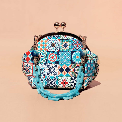 Cocoonese Acrylic Chain Handle Clasp Sling Bag with Peranakan Tiles: vibrant geometric tile patterns, glossy finish, and bold acrylic chain accents
