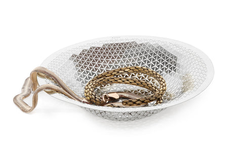 A dish shape Push Solo bowl of stainless steel material being used as a catchall dish to hold small items