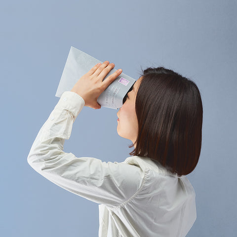A person looking into Fukunage Print star filled envelope which is filled with twinkling lights of the stars and constellation